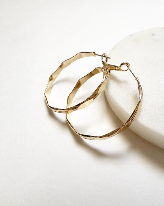 Our Vada Hoops featuring a hammered pattern detailing and a latch back closure.