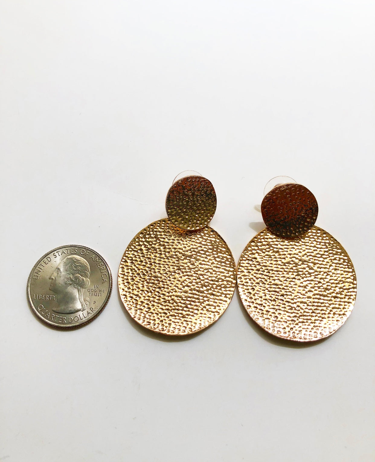 In My Element Earrings shown next to a quarter for size comparison.