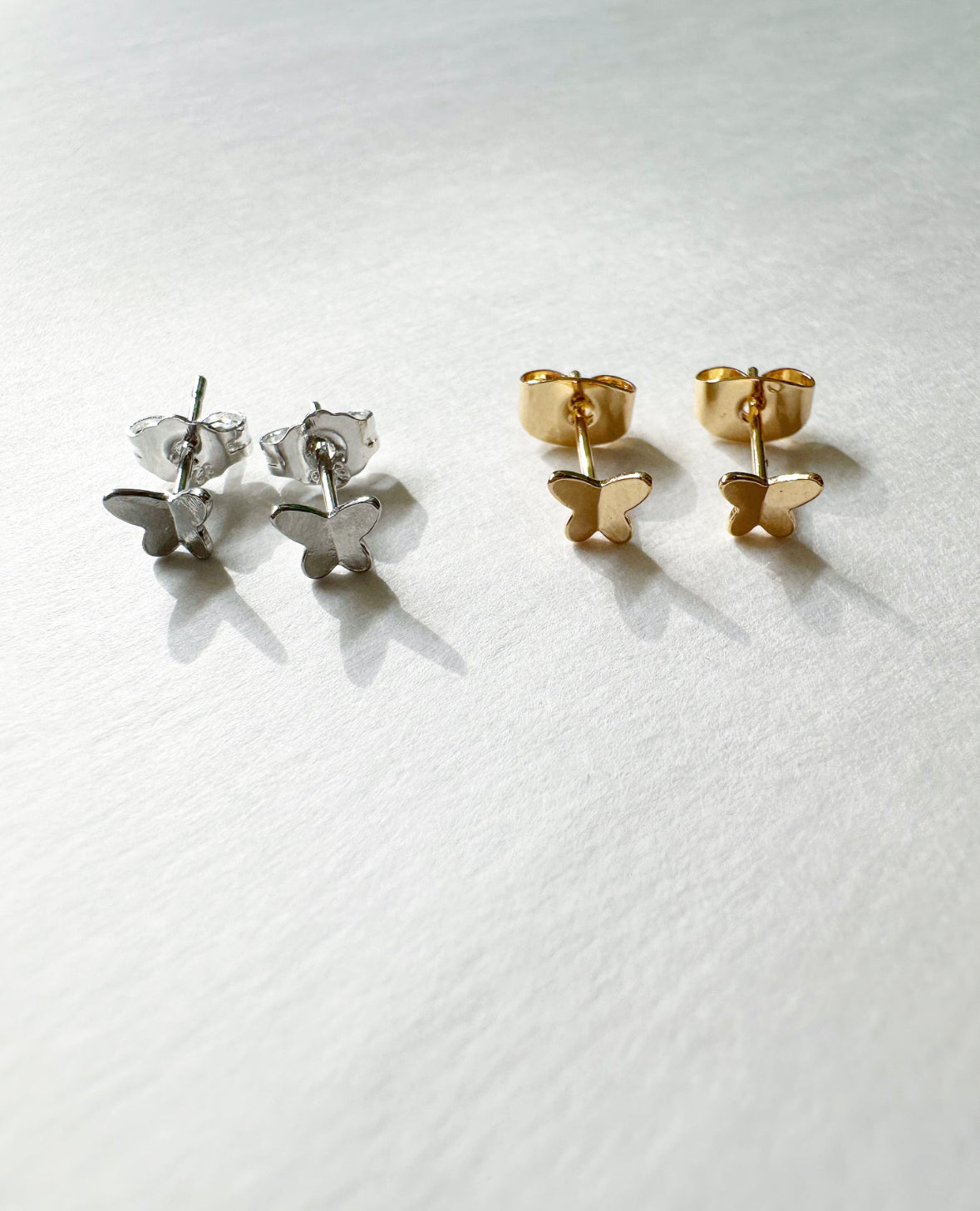 Alternate photo of silver and gold small, butterfly-shaped Tiny Flutters Stud Earrings.